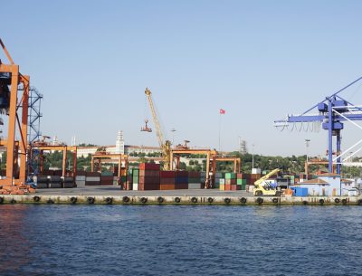 Crane lifting shipping containers at the seaport